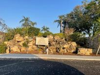 Community sign at 1601 Marsh Hawk Lake Park Condominiums amidst lush landscaping at 1601 43Rd N St # 226, St Petersburg, FL 33713