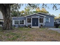 Charming single-story home featuring a gray exterior with white trim and a well-maintained front yard at 1743 Maryland Ne Ave, St Petersburg, FL 33703