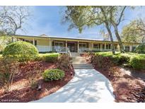 Charming single-story home with landscaped front yard and inviting porch at 2660 Powell Ln, Tarpon Springs, FL 34688