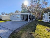 Charming single-story home featuring a screened porch and well-maintained landscaping at 3025 Hickory Dr, Wesley Chapel, FL 33543