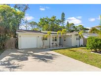 Charming single-story home with a well-manicured lawn and attached garage at 9016 Bay Ne St, St Petersburg, FL 33702