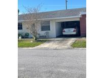 Charming home featuring an attached garage and a well-maintained front yard with seating area at 10002 Daffodil N St # 51, Pinellas Park, FL 33782