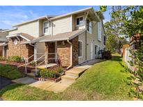 Charming townhome featuring brick accents, neutral siding, landscaped entrance, and well-maintained lawn at 12411 Eagleswood Dr # B, Hudson, FL 34667