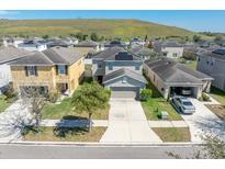 Beautiful two-story home with a well-manicured lawn in a desirable neighborhood at 14422 Scottburgh Glen Dr, Wimauma, FL 33598
