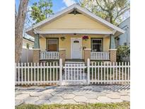 Charming home with a white picket fence, inviting front porch, and colorful landscaping at 322 11Th N Ave, St Petersburg, FL 33701