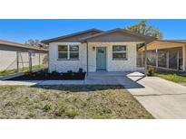 Charming home featuring white stone facade, a light blue door, and manicured landscaping at 3540 Emerson S Ave, St Petersburg, FL 33711