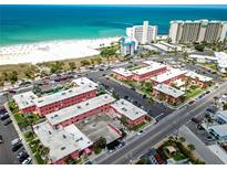 Beautiful aerial view of a beachfront condominium complex with private beach access and stunning ocean views at 6800 Sunset Way # 204, St Pete Beach, FL 33706