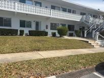 Well-maintained apartment building with nicely landscaped front yard and stairway access to upper floors at 8455 112Th St # 202, Seminole, FL 33772