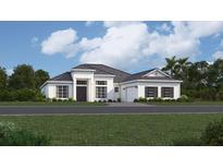 Charming one-story home with a manicured lawn, black shutters, and a two-car garage at 8532 Shore Lake Dr, Englewood, FL 34224