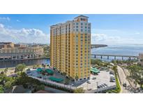 Stunning high-rise condo building overlooking the water on a bright day with palm trees at 345 Bayshore Blvd # P9, Tampa, FL 33606