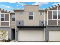 Modern townhouse featuring a two-car garage and neutral-toned exterior at 3460 Timber Crossing Ave, Brandon, FL 33511
