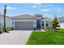 Beautiful one story home features a two car garage, landscaping and brick driveway at 3563 Santa Caterina Blvd, Bradenton, FL 34211