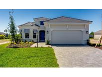 Beautiful single-Gathering home with a well-manicured lawn and paved driveway leading to an attached two-car garage at 3575 Santa Caterina Blvd, Bradenton, FL 34211