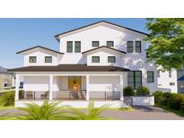 Stunning two-story white home with a charming front porch and dark trim accents at 4809 W Juno St, Tampa, FL 33629