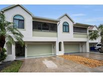 Charming townhouse with a two-car garage and tropical landscaping at 538 Walden Ct, Dunedin, FL 34698