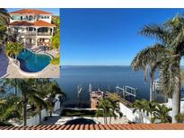 Luxury home showcasing a stunning waterfront view, pool, patio, and private dock at 100 Driftwood W Dr, Palm Harbor, FL 34683