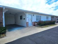 Charming single-story home featuring a covered carport and well-maintained landscaping at 12400 Park Blvd # 408, Seminole, FL 33772