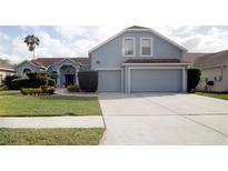 Charming two-story home with well-maintained landscaping and a spacious two car garage at 2233 Golf Manor Blvd, Valrico, FL 33596