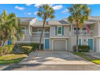 Charming townhouse with two stories, lush landscaping, and an inviting, private entrance with an attached garage at 238 Sun Ketch Ct # 95, Treasure Island, FL 33706