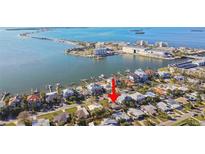 An aerial view shows the waterfront homes and proximity to the beach at 2451 Baywood W Dr, Dunedin, FL 34698