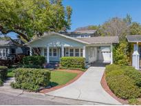 Charming single-story home with a welcoming front porch and well-manicured landscaping at 3007 W Angeles St, Tampa, FL 33629