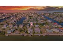 Stunning aerial view of waterfront homes with private docks and canal access at sunset at 4291 Flexer Dr, Hernando Beach, FL 34607