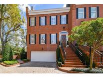 Charming three-story brick townhome featuring classic architecture and a well-manicured front yard at 5105 S Nichol St, Tampa, FL 33611