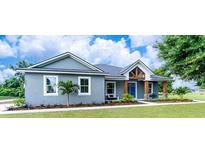 Charming single-story home features a covered porch and well-manicured lawn at 901 Eagle Ln, Apollo Beach, FL 33572