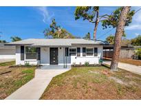 Charming single-story home with a well-maintained lawn, modern front door, and inviting curb appeal at 921 7Th Nw St, Largo, FL 33770
