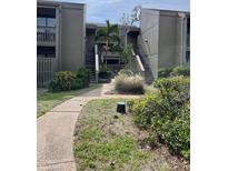 Inviting exterior of a multi-story home with lush landscaping and a serene walkway leading to the entrance at 111 Woodland Pl, Osprey, FL 34229