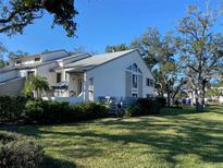 Charming home with landscaped yard, lush greenery, and a clear blue sky at 11450 Harbor Way # 5002, Largo, FL 33774
