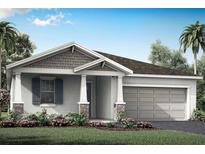 Charming single-story home featuring a two-car garage, landscaped front yard, and covered entryway at 12431 52Nd E St, Parrish, FL 34219