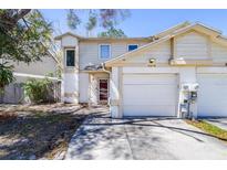 Charming two-story home with an attached garage and well-maintained landscaping at 16858 Le Clare Shores Dr, Tampa, FL 33624