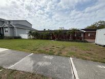 Charming one-story home with a lush front yard and lovely landscaping, offering great curb appeal at 205 S Shore Crest Dr, Tampa, FL 33609