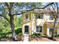 Charming two-story home with neutral siding, complemented by lush landscaping and mature trees at 10906 Johanna Ave, Riverview, FL 33578