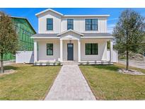 Charming two-story home with a well-manicured lawn and inviting brick pathway at 1239 36Th N Ave, St Petersburg, FL 33704