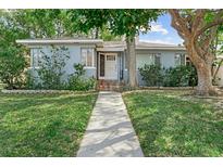 Charming single-story home with a landscaped front yard and inviting entryway with decorative tile steps at 325 Orangeview Ave, Clearwater, FL 33755