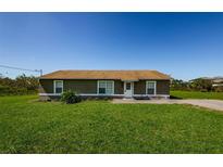 Charming one-story home featuring a well-maintained lawn and a classic, welcoming exterior at 10603 1St St, Riverview, FL 33569