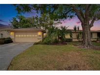 Inviting single-story home featuring mature trees, well-maintained landscaping, and a two-car garage at 1426 Ingram Dr # 1426, Sun City Center, FL 33573