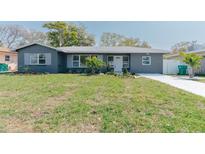 Charming home featuring a well-manicured lawn, freshly painted exterior, and lovely landscaping at 1605 Crown St, Clearwater, FL 33755