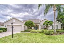 Charming single-story home featuring a well-manicured lawn and lush landscaping at 2926 Spring Hammock Dr, Plant City, FL 33566