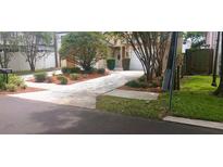 Well-maintained home with fresh landscaping, healthy lawn, and inviting driveway at 409 S Arrawana Ave, Tampa, FL 33609
