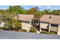 The building's exterior showcases well maintained landscaping at 4160 Pinelake Ln # 201, Tampa, FL 33618