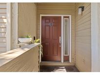 Inviting condo front door featuring a side window, unit number 201, and a plant at 4160 Pinelake Ln # 201, Tampa, FL 33618