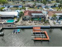 Waterfront property with private dock, boat lift, and a serene canal view; showcasing potential for luxurious living at 727 Flamingo Dr, Apollo Beach, FL 33572