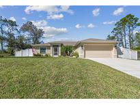 Charming single-story home with a well-manicured lawn and a two-car garage at 1221 Dustin Rd, North Port, FL 34288