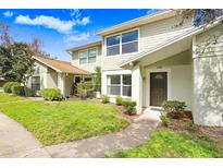 Inviting two-story townhouse with well-manicured lawn and charming curb appeal at 14705 Lake Forest Dr, Lutz, FL 33559