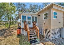 Charming single-story home with a cozy porch and well-maintained landscaping at 1608 Thrush Dr, Zephyrhills, FL 33540