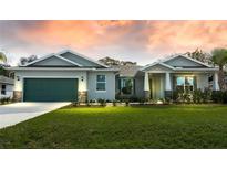 Charming single-story home with a well-maintained lawn, stone accents and a two car garage at 16265 San Edmundo Rd, Punta Gorda, FL 33955