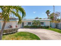 Charming single-story home with circular driveway and tropical landscaping at 2593 W Vina Del Mar Blvd, St Pete Beach, FL 33706